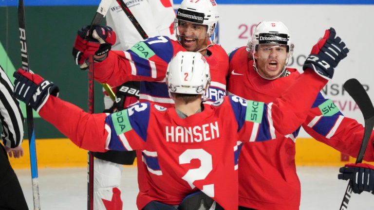 Andreas Martinsen of Norway, rear left, celebrates a goal with Mathias Trettenes, right, and Isak Hansen, front, during the group B match between Canada and Norway at the ice hockey world championship in Riga, Latvia, Monday, May 22, 2023. (Roman Koksarov/AP)