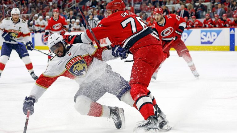 Carolina Hurricanes' Brady Skjei takes Florida Panthers' Anthony Duclair off the puck during the first period of Game 1 of the NHL hockey Stanley Cup Eastern Conference finals in Raleigh, N.C., Thursday, May 18, 2023. (AP Photo/Karl B DeBlaker)