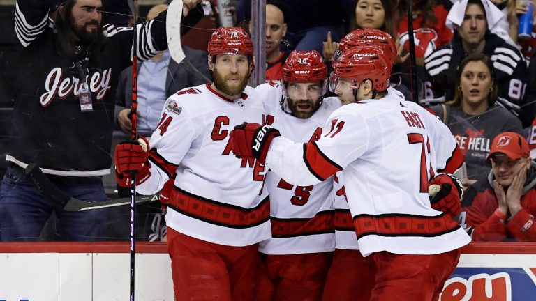 Carolina Hurricanes left wing Jordan Martinook (48) is congratulated by teammates after scoring a goal against the New Jersey Devils during the second period of Game 4 of an NHL hockey Stanley Cup second-round playoff series Tuesday, May 9, 2023, in Newark, N.J. (Adam Hunger/AP)