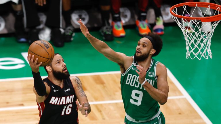 Miami Heat forward Caleb Martin, left, shoots as Boston Celtics guard Derrick White defends during the first half in Game 5 of an NBA basketball Eastern Conference Final series Thursday, May 25, 2023, in Boston. (Michael Dwyer/AP)