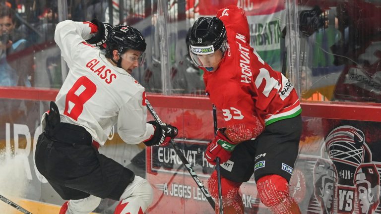 Cody Glass, left, of Canada challenges Milan Horvath of Hungary for the puck during the friendly ice hockey match between Hungary and Canada in Budapest, Hungary, Tuesday, May 9, 2023. (Tibor Illyes/MTI via AP)