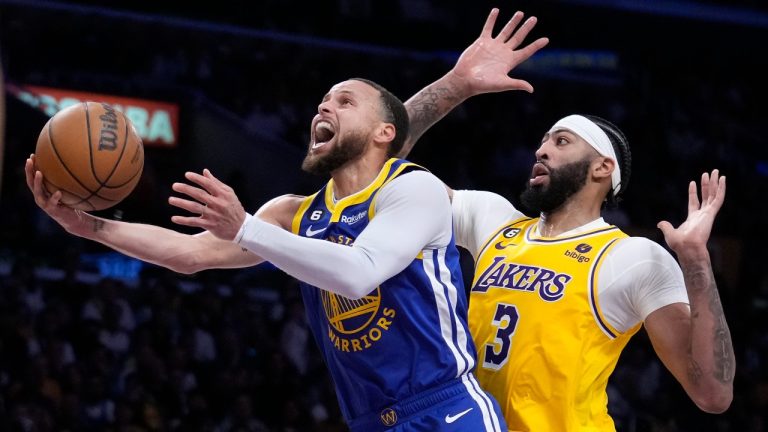 Golden State Warriors guard Stephen Curry, left, shoots as Los Angeles Lakers forward Anthony Davis defends during the first half in Game 4 of an NBA basketball Western Conference semifinal. (Marcio Jose Sanchez/AP)