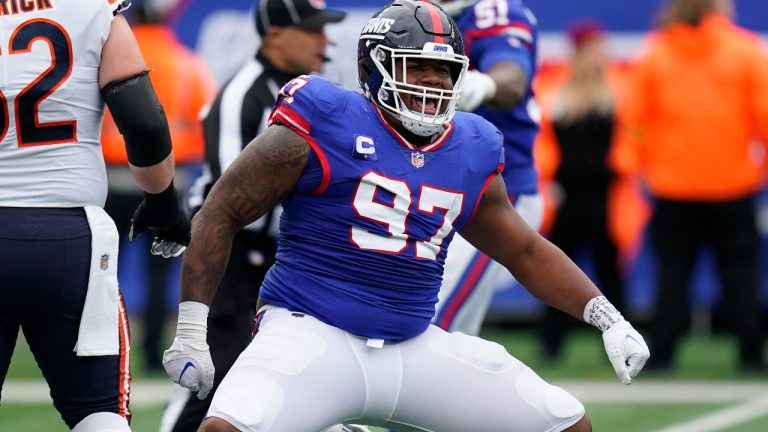 New York Giants defensive tackle Dexter Lawrence (97) reacts after sacking Chicago Bears quarterback Justin Fields (1) during the second quarter of an NFL football game, Sunday, Oct. 2, 2022, in East Rutherford, N.J. (Seth Wenig/AP)