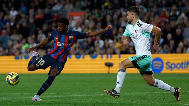 Barcelona's Ansu Fati, left, attempts a shot at goal in front of Osasuna's Iker Munoz during a Spanish La Liga soccer match between Barcelona and Osasuna at the Camp Nou stadium in Barcelona, Spain, Tuesday, May 2, 2023. (Joan Monfort/AP)