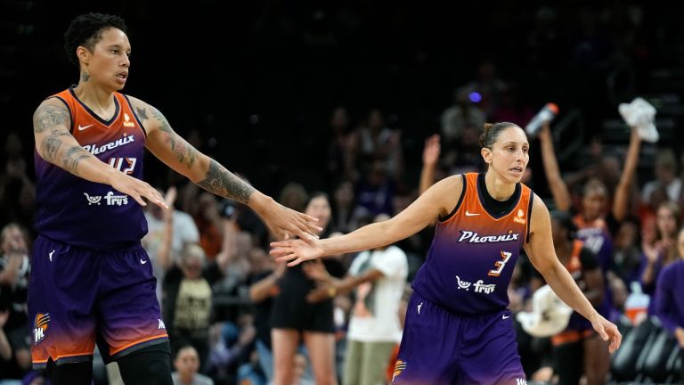 Phoenix Mercury center Brittney Griner, left, celebrates a score by guard Diana Taurasi (3) during the second half of the team's WNBA basketball game against the Minnesota Lynx. (Ross D. Franklin/AP) 