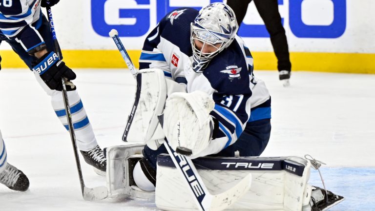 Winnipeg Jets goaltender Connor Hellebuyck (37) stops a Vegas Golden Knights shot during the second period of Game 5 of an NHL hockey Stanley Cup first-round playoff series Thursday, April 27, 2023, in Las Vegas. (David Becker/AP)