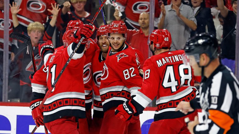 Carolina Hurricanes' Jesperi Kotkaniemi (82) turns to welcome Jordan Martinook (48) to a celebration following his goalduring the Stanley Cup Playoffs. (Karl B DeBlaker/AP)