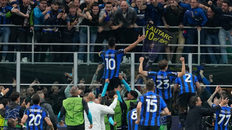 Inter Milan's Lautaro Martinez, centre, celebrates after scoring his side's opening goal during the Champions League semifinal second leg soccer match between Inter Milan and AC Milan at the San Siro stadium in Milan, Italy, Tuesday, May 16, 2023. (Antonio Calanni/AP)