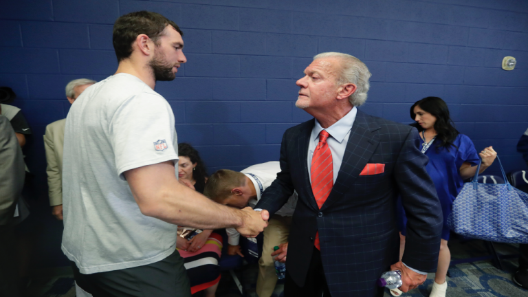 Former Indianapolis Colts quarterback Andrew Luck shakes hands with Indianapolis Colts owner Jim Irsay after a news conference following the team's NFL preseason football game against the Chicago Bears, Saturday, Aug. 24, 2019, in Indianapolis. (Michael Conroy/AP)