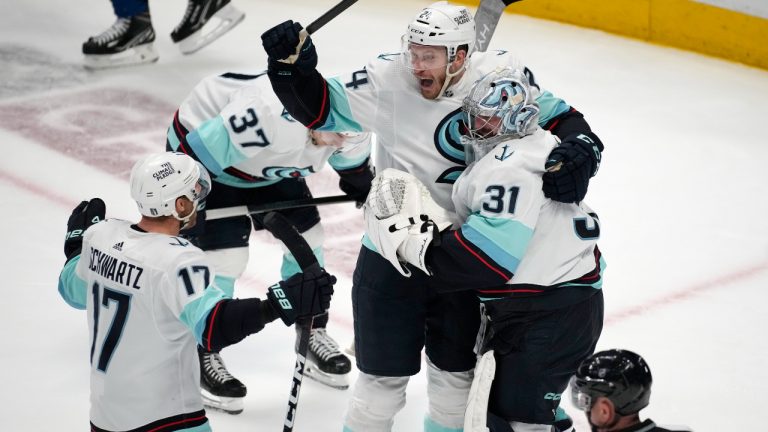 From left, Seattle Kraken center Jaden Schwartz, defenseman Jamie Oleksiak and goaltender Philipp Grubauer celebrate as time runs out in the third period of Game 7 of an NHL first-round playoff series against the Colorado Avalanche Sunday, April 30, 2023, in Denver. The Kraken won 2-1 to advance to the next round. (David Zalubowski/AP)