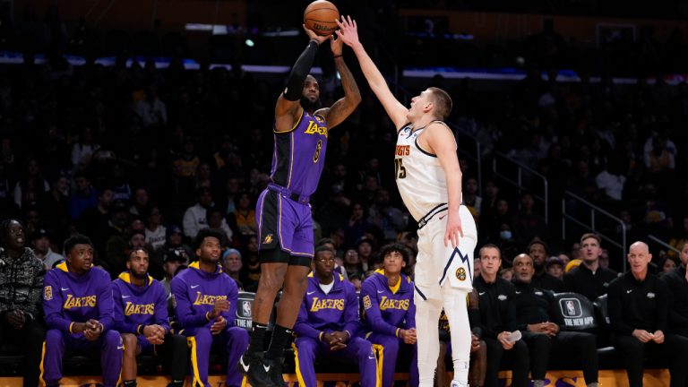 Los Angeles Lakers forward LeBron James (6) shoots against Denver Nuggets center Nikola Jokic (15) during the first half of an NBA basketball game. (Ashley Landis/AP)