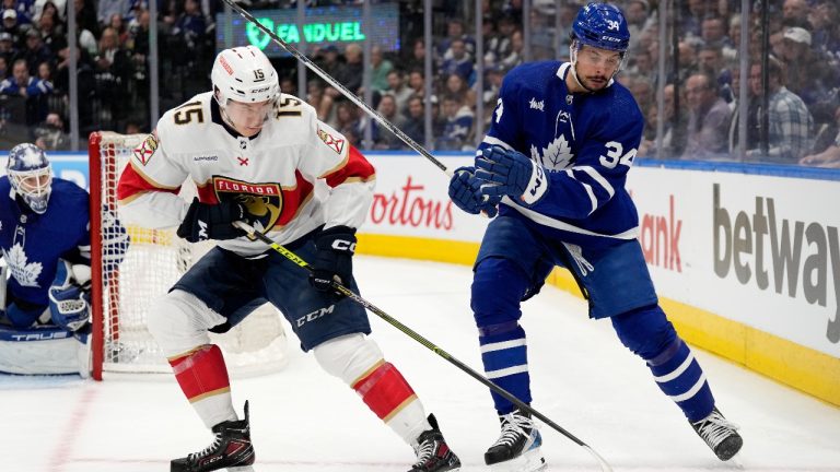 Florida Panthers centre Anton Lundell (15) moves the puck under pressure from Toronto Maple Leafs centre Auston Matthews (34) during first period, second round, game one, NHL Stanley Cup hockey action in Toronto, Tuesday, May 2, 2023. (Frank Gunn/CP)