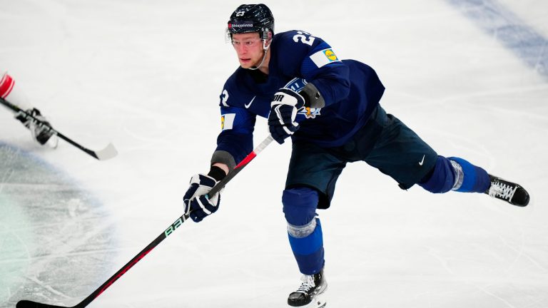 Finland's Nikolas Matinpalo passes the puck during the group A match between Finland and Denmark at the ice hockey world championship in Tampere, Finland, Tuesday, May 23, 2023. (Pavel Golovkin/AP)