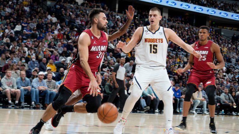 Miami Heat guard Max Strus, left, drives through the lane as Denver Nuggets center Nikola Jokic (15) defends. (AP)