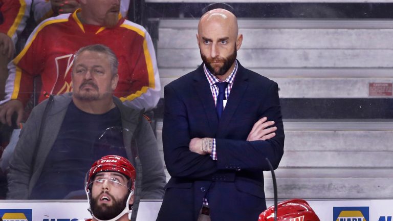 AHL (American Hockey League) profile photo on Calgary Wranglers head coach Mitch Love, top, during a game against the Coachella Valley Firebirds in Calgary, Alta., May 11, 2023. (CP)