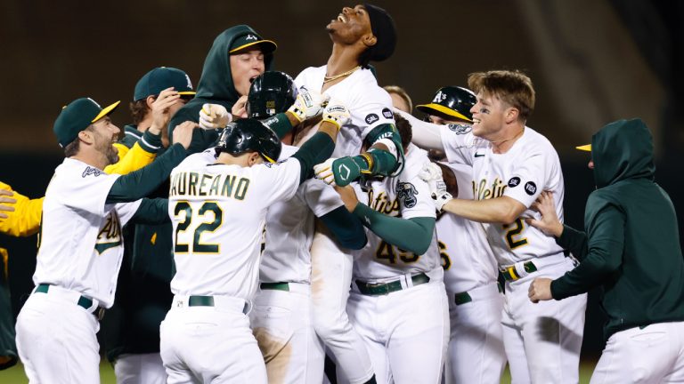 Oakland Athletics' Esteury Ruiz, centre, celebrates with teammates after a game winning single during the 12th inning of a baseball game against the Arizona Diamondbacks in Oakland, Calif., Tuesday, May 16, 2023. (Jed Jacobsohn/AP)