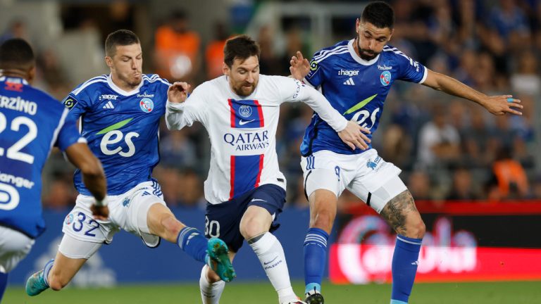 PSG's Lionel Messi, centre, challenges for the ball with Strasbourg's Frederic Guilbert, left, and Strasbourg's Kevin Gameiro, right, during the French League One soccer match between Strasbourg and Paris Saint Germain at Stade de la Meinau stadium in Strasbourg, eastern France, Saturday, May 27, 2023. (AP)