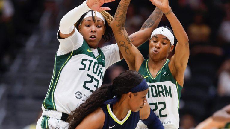 Seattle Storm forward Jordan Horston, left, and guard Yvonne Turner double-team Dallas Wings guard Arike Ogunbowale during the first half of a WNBA basketball game Friday, May 26, 2023, in Seattle. (Jennifer Buchanan/The Seattle Times via AP)