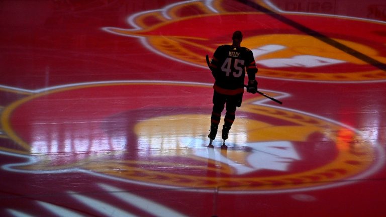 Ottawa Senators left wing Parker Kelly (45) skates as projections of the team's logo spin on the ice before an NHL game against the Boston Bruins in Ottawa. (Justin Tang/CP)