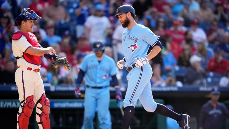 Toronto Blue Jays' Brandon Belt, right, rounds the bases past Philadelphia Phillies catcher J.T. Realmuto after hitting a home run during the fifth inning of a baseball game, Wednesday, May 10, 2023, in Philadelphia. (Matt Slocum/AP)