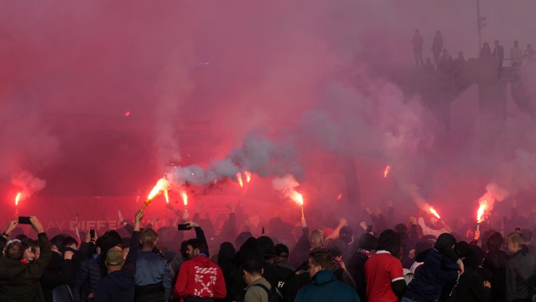 AZ supporters, some holding flares, meet the players' bus before the Conference League second leg semifinal soccer match between AZ Alkmaar and West Ham at the AZ stadium in Alkmaar, Netherlands, Thursday, May 18, 2023. (Peter Dejong/AP)