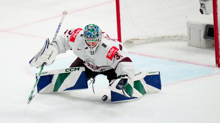 Latvia's goalie Arturs Silovs (31) stops the puck at the net in their bronze medal match against the United States at the Ice Hockey World Championship in Tampere, Finland, Sunday, May 28, 2023. Latvia won 4-3. (Pavel Golovkin/AP)