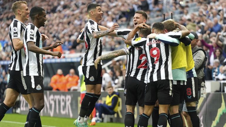 Newcastle United celebrate after Brighton and Hove Albion's Deniz Undav scores an own goal during the English Premier League soccer match at St. James' Park, Newcastle, England, Thursday May 18, 2023. (Owen Humphreys/PA via AP)