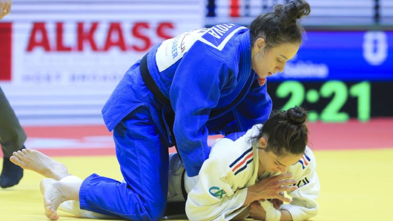 Sabina Giliazova of Russia and Blandine Pont of France, bottom, in action during the women's -48 category at the World Judo Championships in Doha, Qatar, Sunday, April 5, 2023. (Hussein Sayed/AP)