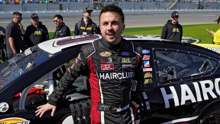 FILE - Actor turned race car driver Frankie Muniz leans on his car before the ARCA 200 auto race Feb. 18, 2023, at Daytona International Speedway in Daytona Beach, Fla. Muniz is the surprising points leader in the ARCA Series heading into Saturday’s race at Kansas Speedway in his first full season in stock car racing. (Chris O'Meara/AP, File)