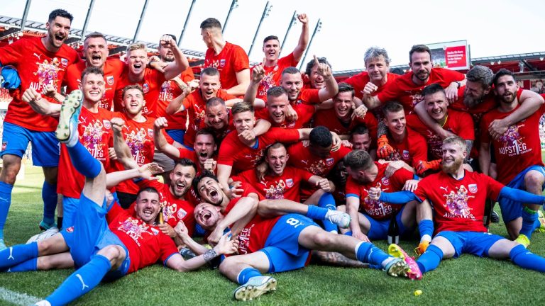 The players of FC Heidenheim celebrate winning their first Bundesliga soccer championship after their match against Jahn Regensburg in Regensburg, Germany, Sunday, May 28, 2023.(Tom Weller/dpa via AP)