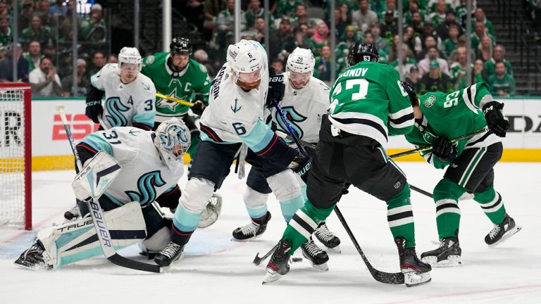 Seattle Kraken goaltender Philipp Grubauer (31) gets help from Adam Larsson (6) and Vince Dunn (29) while defending against an attack by Dallas Stars right wing Evgenii Dadonov (63) and Wyatt Johnston (53) in the first period of Game 7 of an NHL hockey Stanley Cup second-round playoff series. (Tony Gutierrez/AP)