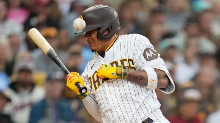 San Diego Padres' Manny Machado reacts after being hit by a pitch while batting during the second inning of a baseball game against the Kansas City Royals, Monday, May 15, 2023, in San Diego. San Diego Padres' Austin Nola scored from third on the play. (Gregory Bull/AP Photo)