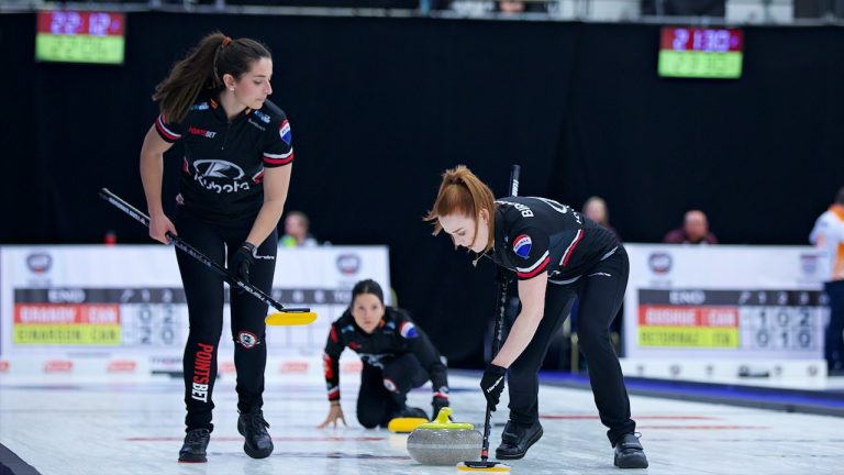 Lead Dawn McEwen (right) sweeps a stone for skip Kerri Einarson (centre) as second Shannon Birchard (left) watches on during the fifth round-robin draw of the KIOTI Tractor Champions Cup on Wednesday, May 3, 2023, in Regina. (Anil Mungal/GSOC)