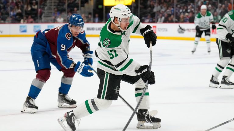 Dallas Stars centre Logan Stankoven (57) takes a shot on goal as Colorado Avalanche center Evan Rodrigues (9) defends during the third period of an NHL preseason hockey game Wednesday, Oct. 5, 2022, in Denver. (Jack Dempsey/AP Photo)