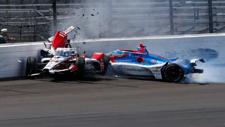 Katherine Legge, of England, left, and Stefan Wilson, of England, crash in the first turn during practice for the Indianapolis 500 auto race at Indianapolis Motor Speedway in Indianapolis, Tuesday, May 23, 2023. (Kirk DeBrunner/AP)