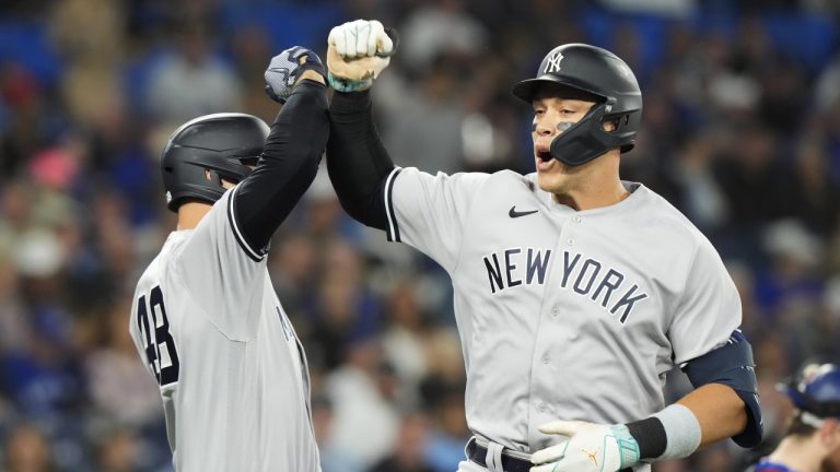 New York Yankees designated hitter Aaron Judge (99) celebrates his two-run home run against the Toronto Blue Jays with teammate Anthony Rizzo (48) during first inning MLB American League baseball action in Toronto, on Thursday, May 18, 2023. (Frank Gunn/CP)