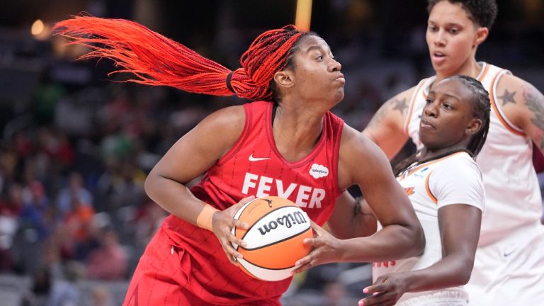 Indiana Fever's Aliyah Boston, left, goes to the basket against Phoenix Mercury's Michaela Onyenwere, front right, during the second half of a WNBA basketball game, Sunday, June 11, 2023, in Indianapolis. (AP)