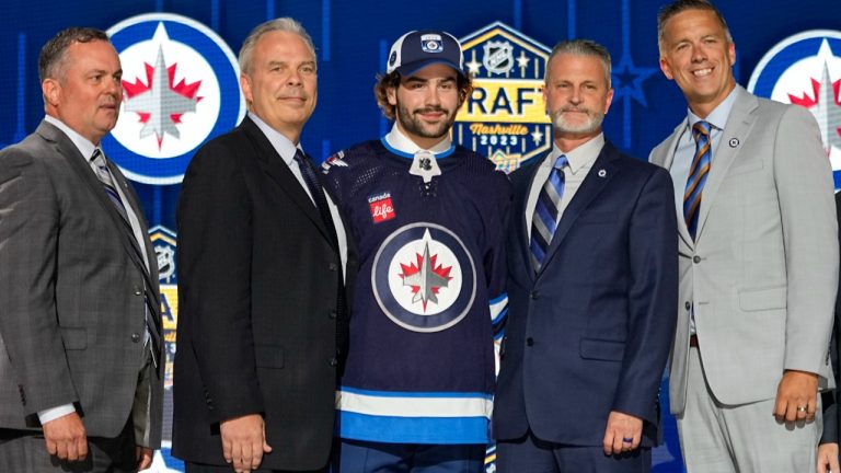 Colby Barlow, center left, poses with Winnipeg Jets officials after being picked by the team during the first round of the NHL hockey draft. (George Walker IV/AP)