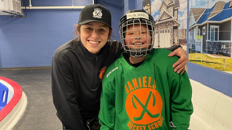 Winnipeg Jets scout Sydney Daniels poses with a young athlete at her family's hockey school. (Photo courtesy of Daniels Hockey)