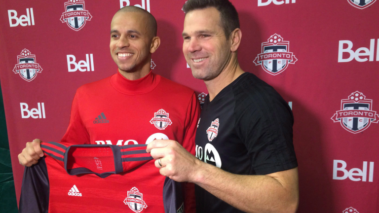 Defender Jason Hernandez (left) poses with Toronto FC coach Greg Vanney in Toronto. (CP)