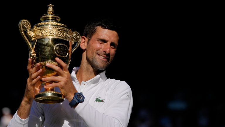 Serbia's Novak Djokovic celebrates with the trophy after beating Australia's Nick Kyrgios in the final of the men's singles on day fourteen of the Wimbledon tennis championships in London, Sunday, July 10, 2022. (Kirsty Wigglesworth/AP)