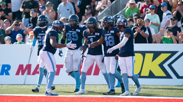 Toronto Argonauts' Wynton McManis, second from right, celebrates with teammates after running back a touchdown on an interception during the second half of CFL action against the Saskatchewan Roughriders at Acadia University in Wolfville, N.S., Saturday, July 16, 2022 (CP)