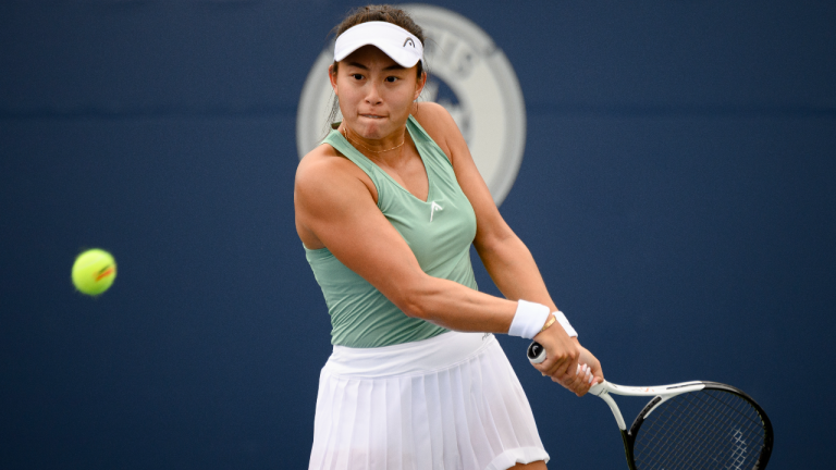 Carol Zhao, of Canada, returns the ball during a match against Amanda Anisimova, of the USA, at the National Bank Open tennis tournament in Toronto, on Tuesday, Aug. 9, 2022. (Christopher Katsarov/CP)