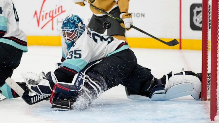 Seattle Kraken goaltender Joey Daccord (35) deflects the puck against the Vegas Golden Knights during the second period of an NHL hockey game Tuesday, April 11, 2023, in Las Vegas. (John Locher/AP)