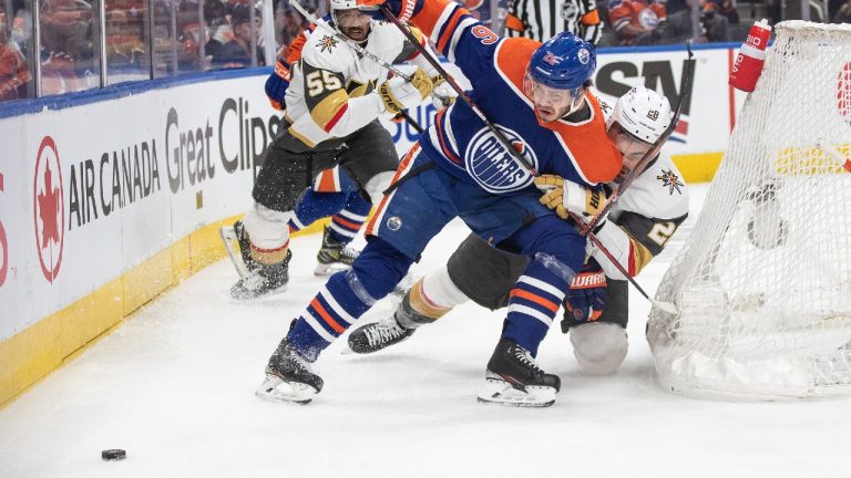 Vegas Golden Knights' William Carrier (28) and Edmonton Oilers' Mattias Janmark (26) battle for the puck during first period NHL Stanley Cup second round playoff action in Edmonton on Sunday May 14, 2023. (Jason Franson/CP)