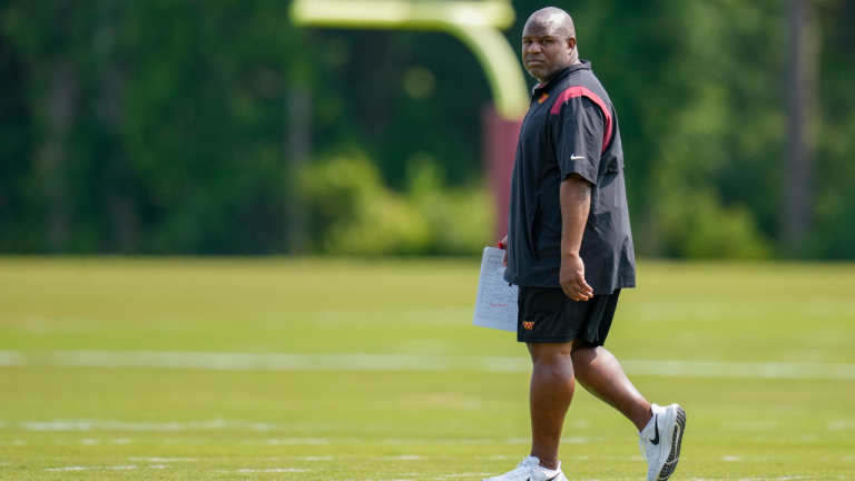 Washington Commanders assistant head coach Eric Bieniemy walks on the field during an NFL football practice at the team's training facility, Wednesday, May 24, 2023 in Ashburn, Va. (AP Photo/Alex Brandon)