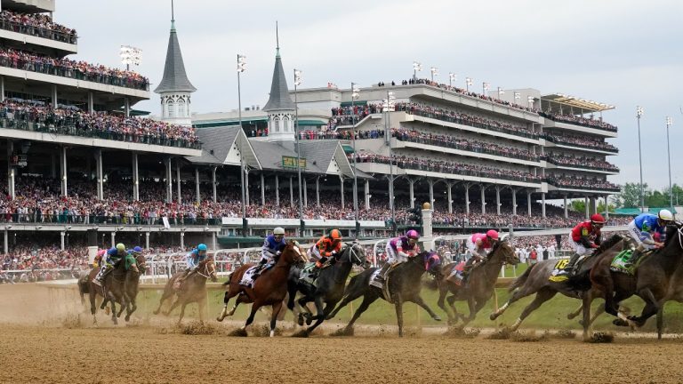 Javier Castellano, atop Mage, third from left, is seen behind with others behind the pack as they make the first turn while competing in the 149th running of the Kentucky Derby horse race at Churchill Downs Saturday, May 6, 2023, in Louisville, Ky. Churchill Downs will limit horses to four starts during a rolling eight-week period and impose ineligibility standards for continued poor performance in the wake of the recent deaths of 12 horses at the home of the Kentucky Derby. (AP Photo/Julio Cortez, File)