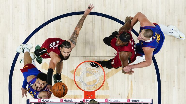 Denver Nuggets guard Jamal Murray, lower left, shoots while defended by Miami Heat forward Caleb Martin (16) during the first half of Game 1 of basketball's NBA Finals, Thursday, June 1, 2023, in Denver. At right are Heat's Jimmy Butler and Nuggets' Nikola Jokic. (Jack Dempsey/AP)