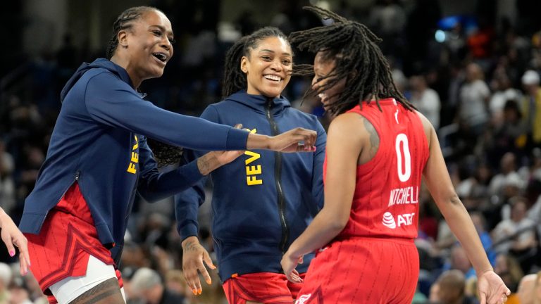 Indiana Fever's Kelsey Mitchell (0) is congratulated by teammates after her go-ahead basket to give her team the win over the Chicago Sky during the second half of a WNBA basketball game Thursday, June 15, 2023, in Chicago. (AP Photo/Charles Rex Arbogast)