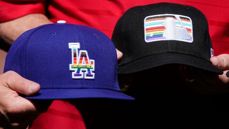 Pride-themed hats for the Los Angeles Dodgers and Major League Baseball are displayed by sports officials on Pride Day at Oracle Park before a baseball game between the Giants and the Dodgers in San Francisco, Saturday, June 11, 2022. (AP)